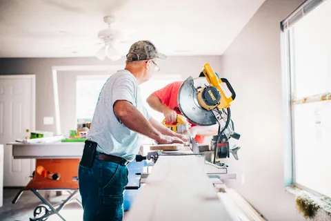 Contractor using a miter saw